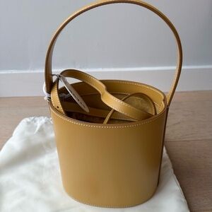 STAUD Yellow Crossbody Leather Bag with Classic Bucket Shape and Elegant Handle
